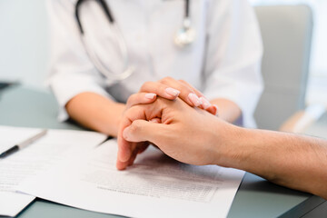 Care, support or nurse doctor holding hands with person for healthcare service, wellness or empathy. Sympathy, closeup and caregiver helping for comfort, trust or patient for medical check or nursing