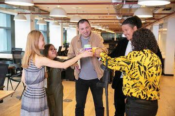Business people raising toast in office