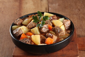 Prato de carne com legumes e decoração com salsa