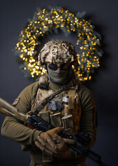 soldier on the background of a Christmas wreath. military Christmas