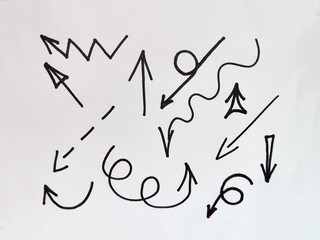 Various black lines and arrows create an abstract representation of movement and direction against a plain white background