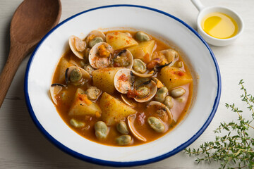 Fish stew with clams, potatoes and green beans. Traditional Spanish recipe.