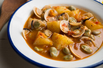 Fish stew with clams, potatoes and green beans. Traditional Spanish recipe.