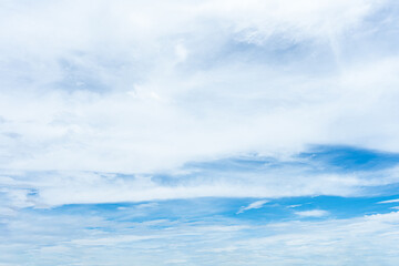 Beautiful blue sky with fluffy white clouds, reflecting on the calm ocean waters