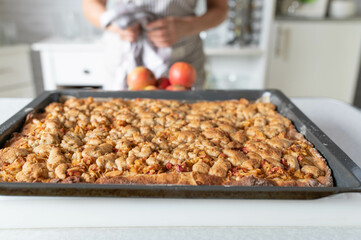 Apple crumble cake fresh and homemade baked with hazelnuts on kitchen counter
