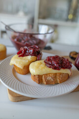 Baked open cheese sandwich baguette mit homemade plum chutney on kitchen background