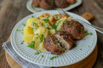 German pork meatballs or frikadellen with potatoes and creamy vegetables. Traditional rustic dinner