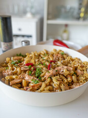 Pasta with salmon and garlic butter in a skillet fresh and homemade cooked on kitchen background