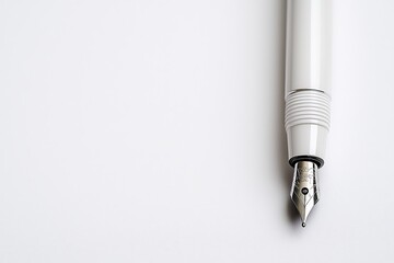 Elegant Silver Fountain Pen Closeup on White Surface - Modern Minimalist Writing Tool for Luxurious Creations