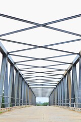 A metal truss bridge spans the road.