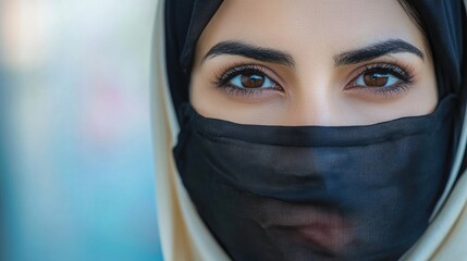 Close-up portrait of a woman's eyes, covered by a veil.