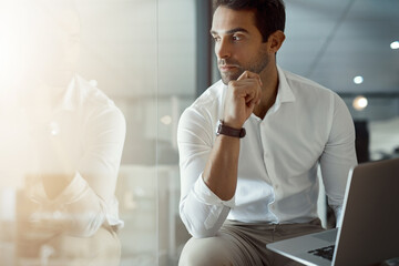 Laptop, vision and business man thinking, brainstorming idea or insight for sales growth. Serious,...