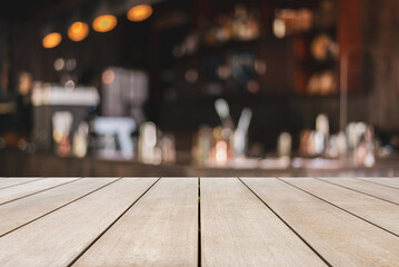 Wooden table top and blurred background in vintage coffee shop and restaurant walls of the shop are built with old red bricks modern vintage loft style, Mock up for display of product.