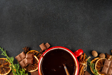 Dark sweet hot chocolate ceramic pan with ingredients on table. Making traditional spicy hot chocolate or cocoa drink, copy space