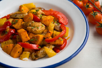 Stir-fried chicken with sweet potato, pineapple and red pepper. Top view table with  decorations.
