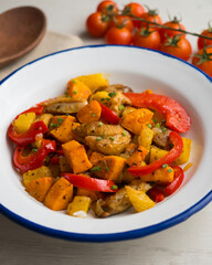 Stir-fried chicken with sweet potato, pineapple and red pepper. Top view table with  decorations.