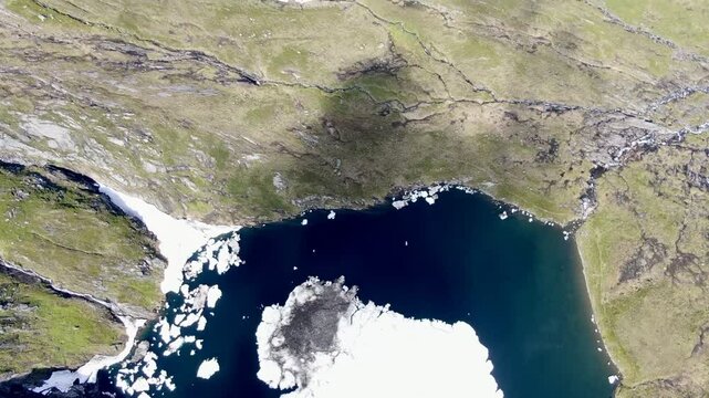 Aerial view of &Aring;vatnet lake with floating ice and the valley of Nordre Vartdal in &Oslash;rsta, Norway