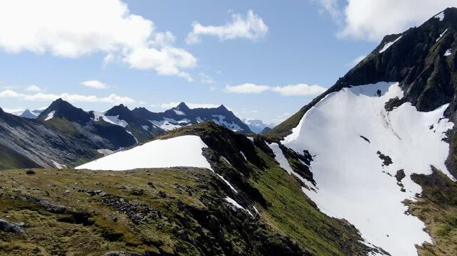 Snow covered mountains of &Oslash;rsta under a bright blue sky. &Aring;vasstinden peak rising to the right.