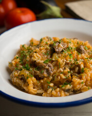 Rice paella with Iberian pork cheek. Traditional spanish tapa with iberic pork.