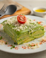 Baked potatoes with spinach bechamel and cheese.
