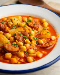 Chickpea stew with vegetables and chorizo. Traditional Spanish tapa recipe.