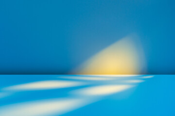 Abstract blue background for product presentation with sunlight and blurred shadows wall. Winter...