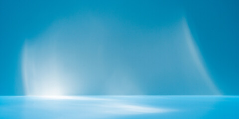 Panoramic abstract blue background for product presentation with sunlight and blurred shadows wall. Winter background.

