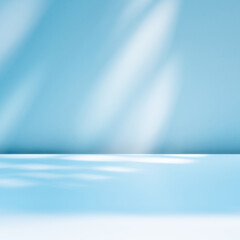 Abstract blue background for product presentation with sunlight and blurred shadows wall. Winter background.
