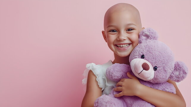 Little smiling girl with purple teddy bear on pink background. Cancer treatment healing. World day against cancer, lupus
