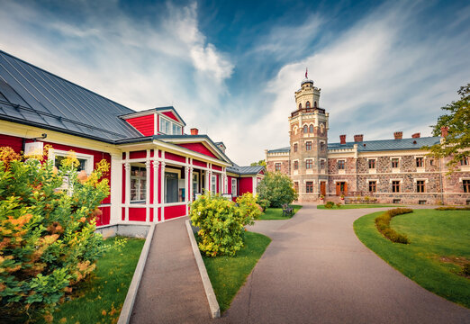 Sunny morning view of Sigulda New Castle with green meadow and empty tourist path . Impressive summer cityscape Sigulda town, Siguldas novads, Latvia, Europe. Traveling concept background.