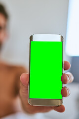 Hand, person or phone with green screen in home for marketing, online dating or ads on app. Closeup, chroma key or mobile display for social media, mockup space or show info presentation for discount