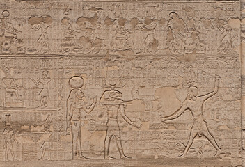 Hieroglyphic carvings on an ancient egyptian temple wall