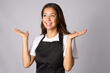 Friendly waitress, female barista in black apron introduce new product