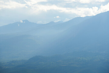Colombian Andean landscape, Layers of mountains that extend, covered with vegetation, to the cloudy horizon.