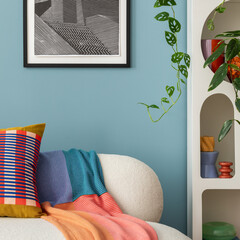 Interior desgin of modern living room interior with mock up poster frame, colorful decorations and accessories, plants, sofa, coffee table. Blue wall. Home decor. Template