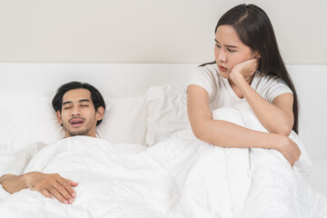 Snoring couple health concept, asian man snore and sleeping at home while woman, wife insomnia...