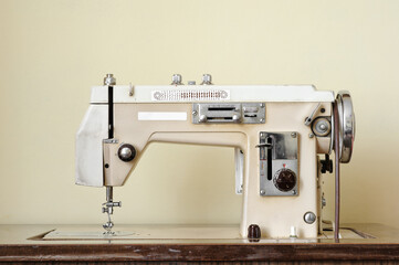 Old sewing machine with wooden table.