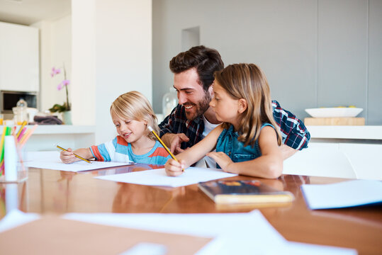 Father, children and paper in home for education, distance learning and creativity for growth. Dad, kids and happy at table for fun activity, art project and drawing skill development in lesson