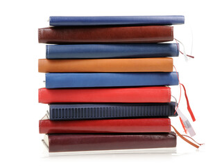 Stack of diaries or books with colorful covers on white background
