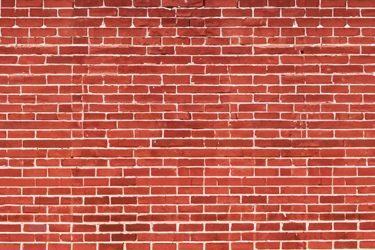 Fototapeta A brick wall with red bricks and white mortar.
