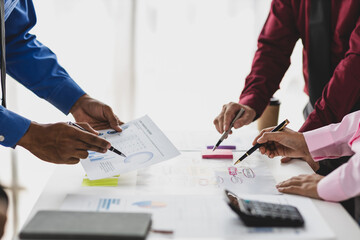 Businessman meeting with colleagues are discussing business situation analysis by charts in financial reports and making plans to increase company profits.