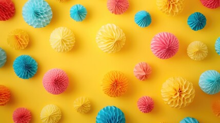 Vibrant yellow backdrop adorned with colorful paper balls Ideal for greeting cards birthday celebrations invitations or festive events Ample copy space viewed from above flat lay style