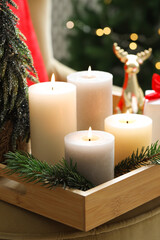 Tray with burning candles and Christmas decor on blurred background