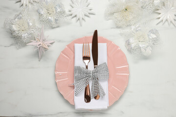 Christmas place setting with festive decor on white marble table, flat lay