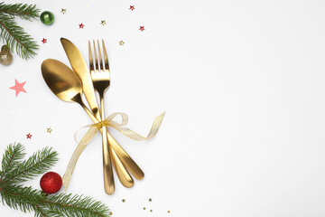 Christmas table setting with plate, cutlery and festive decor on white background, flat lay. Space for text