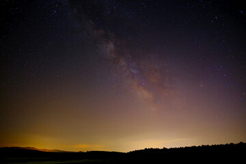 Naklejka premium Starry sky and Milky Way arc, with details of its colorful core, outstandingly bright, view from frig valley.
