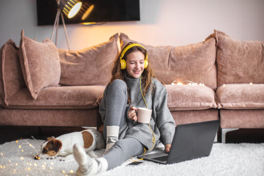 Attractive young woman with laptop at home - Powered by Adobe