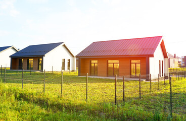 Barn House in village on sunset. Modern Architect-designed house. Wooden Scandi home in rural....
