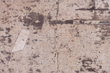 Old and dirty canvas with a patch. Texture of a worn canvas with drips and spots of faded paint, close-up, high resolution.