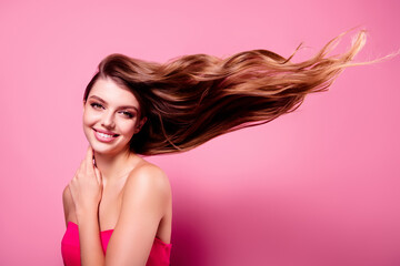 Photo of lovely young girl toothy smile flying hair wear dress isolated on pink color background